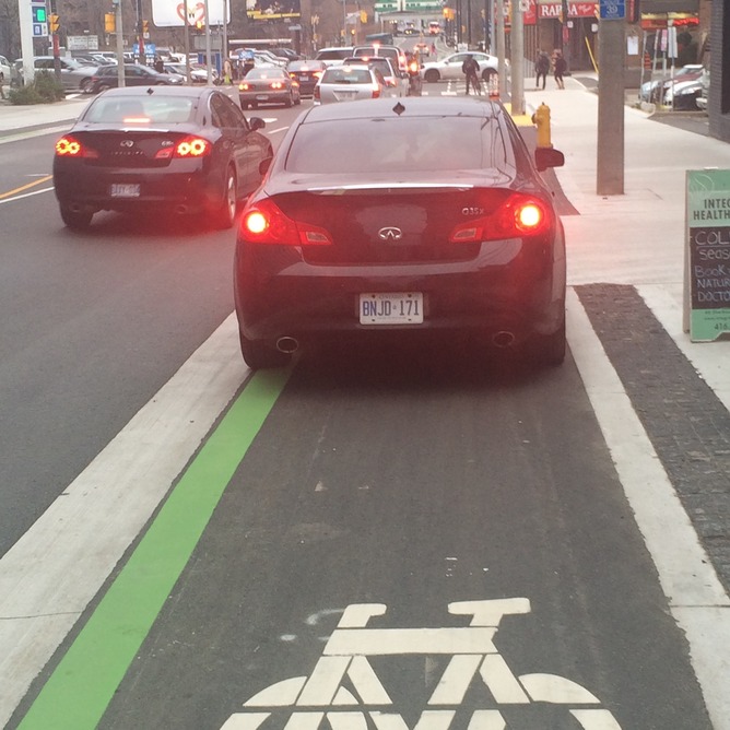 Car parked in protected bike lane